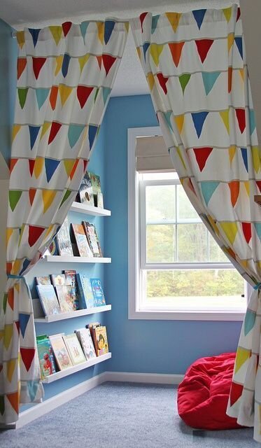 Kids reading nook with colorful curtains