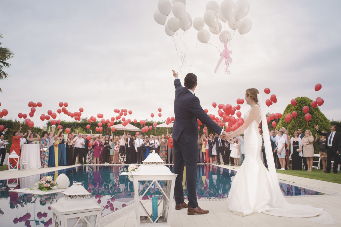 Wedding Couple Releasing Balloons Into The Sky